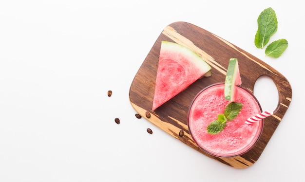 Top view of  watermelon cocktail glass on chopping board with copy space