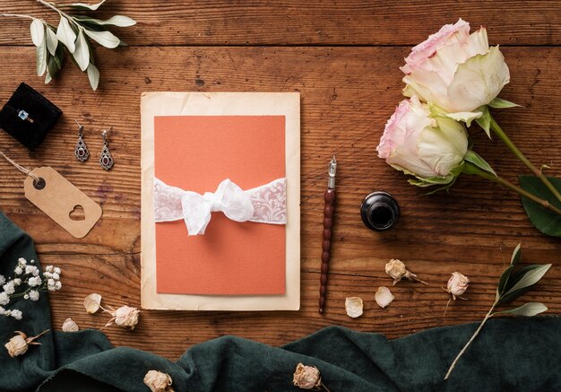 Top view wedding card and roses beside