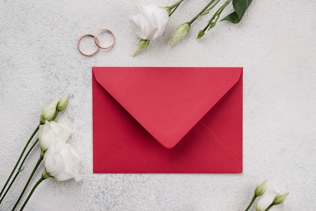 Top view wedding invitation card with flowers on the table