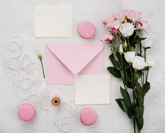 Free photo top view wedding invitation cards with flowers