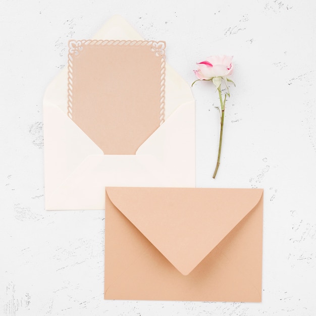 Top view wedding invitation envelopes and flowers