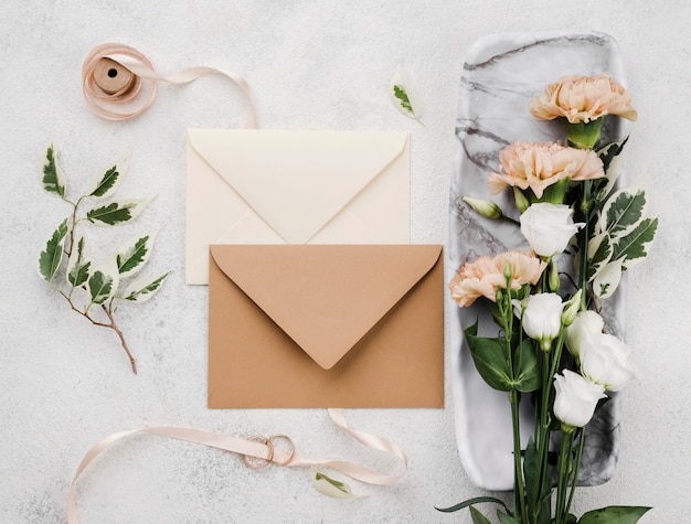 Top view wedding invitation envelopes with flowers