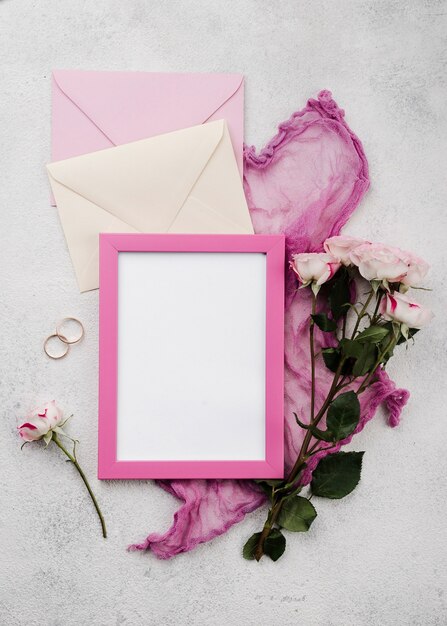 Top view wedding invitation envelopes with flowers