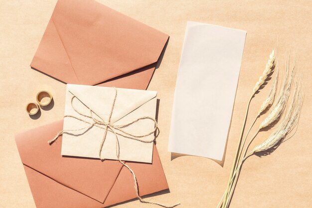 Top view wedding invitations in envelopes with paper background