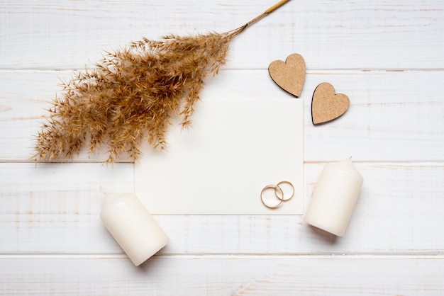 Free photo top view wedding rings with candles on the table