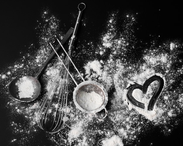 Top view whisk with sugar powder on the table