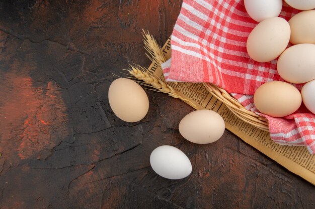 Top view white chicken eggs on a dark table