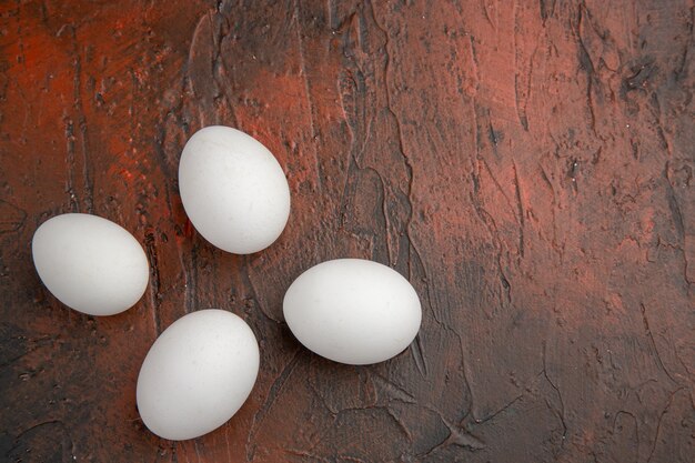 Top view white chicken eggs on dark table