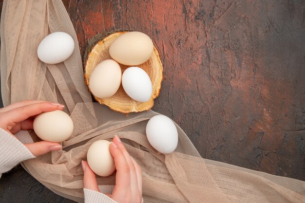 Top view white chicken eggs on dark table