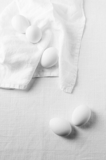 Top view white eggs with kitchen towel