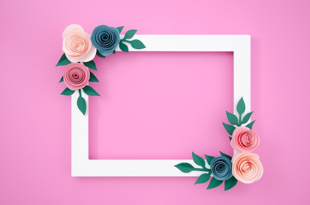 Top view white floral frame on pink background