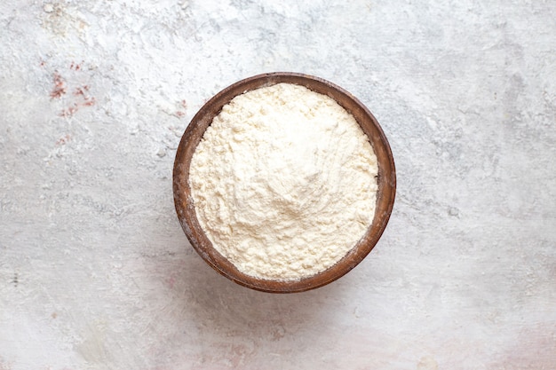 Top view white flour inside plate on white background flour dust dough bake raw