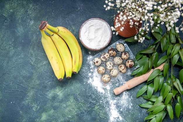 Free photo top view white flour with bananas and eggs on dark blue background dough food pastry oven cake pie dust bake