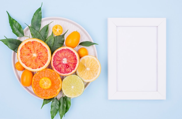 Top view white frame with tasty fruits