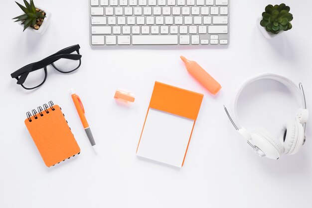 Top view of white office desktop with office supplies