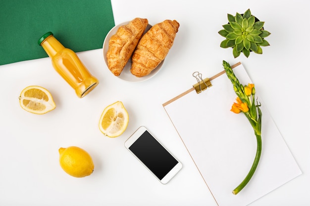 Foto gratuita vista superiore dell'area di lavoro femminile dell'ufficio bianco con il taccuino