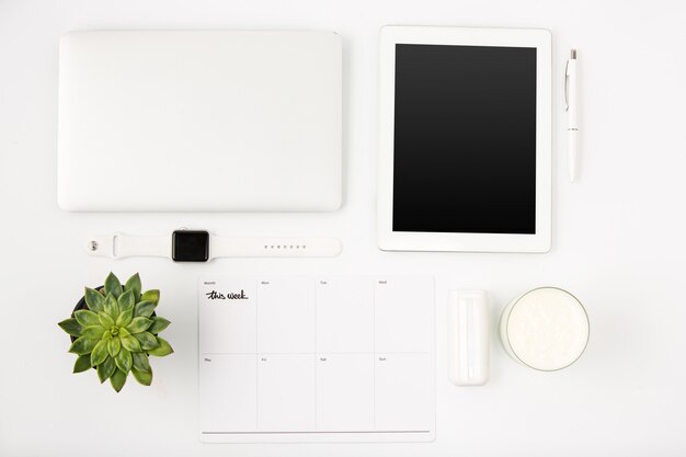 Top view of white office table with laptop