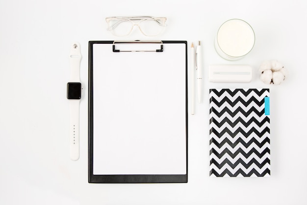 Top view of white office table with notebook