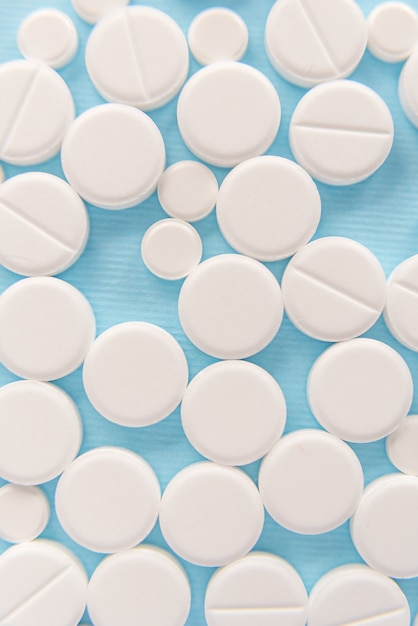 Top view of white pills and tablets