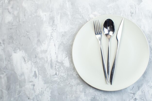 Top view white plate with cutlery on white surface colour kitchen food meal cuisine horizontal glass