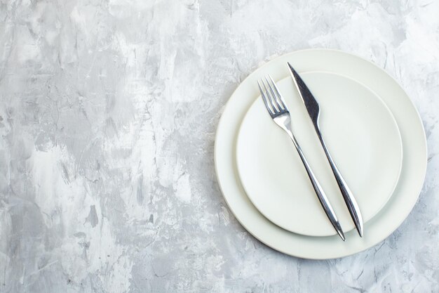 Top view white plates with fork and knife on white surface colour meal cuisine horizontal glass food