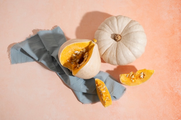 Free photo top view white pumpkins and cloth arrangement