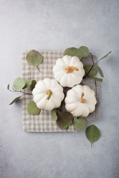 Top view white pumpkins and leaves