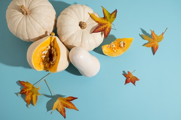 Top view white pumpkins and leaves