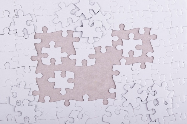 Free photo top view white puzzle pieces arrangement