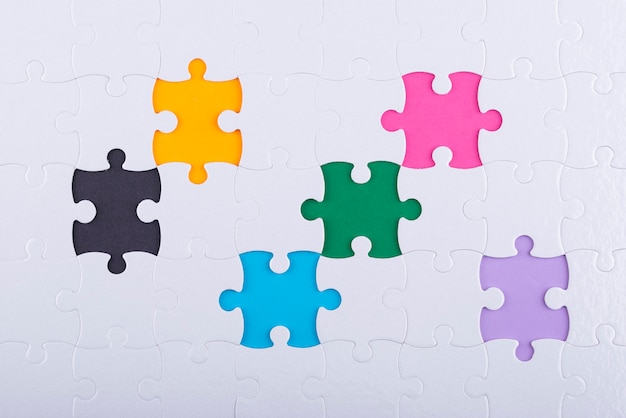 Top view white puzzle pieces and colorful background