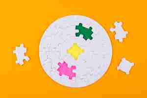 Free photo top view white puzzle pieces missing