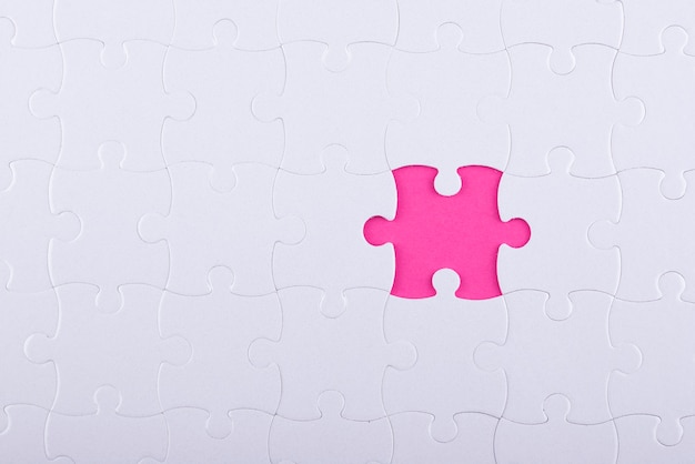 Top view white puzzle pieces and pink background