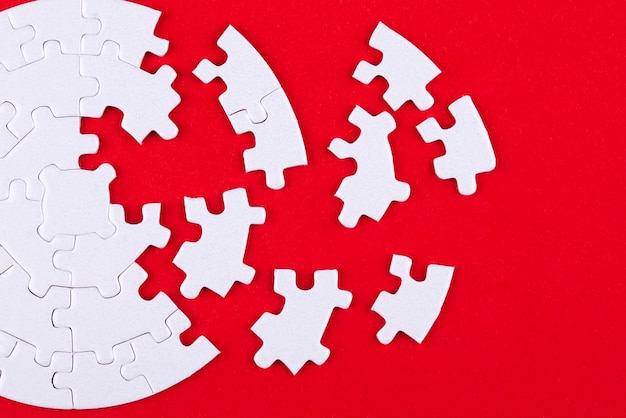 Top view white puzzle pieces and red background