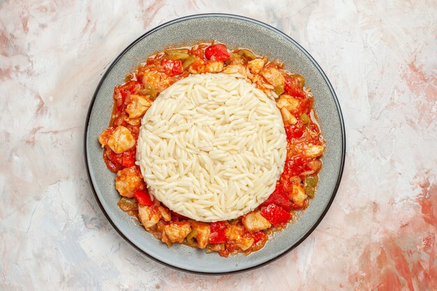 Top view of white rice meal with chicken and vegetables