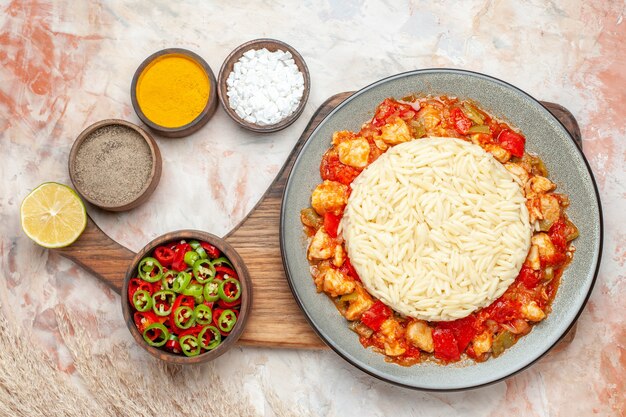 Top view of white rice with chicken and various spices pepper salad lemon