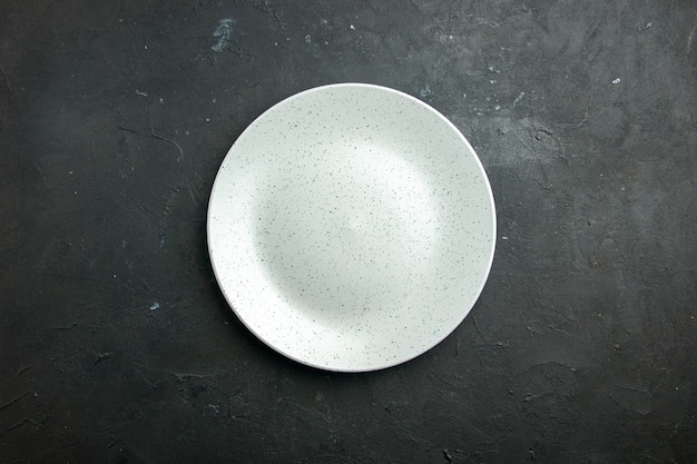 Top view white round plate on dark table with copy place