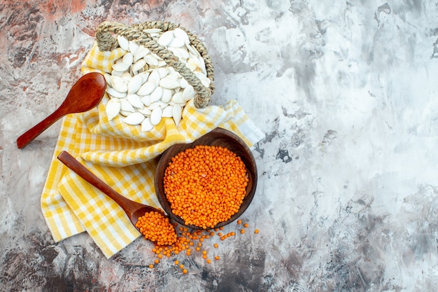 Top view white seeds with orange lentils on light surface