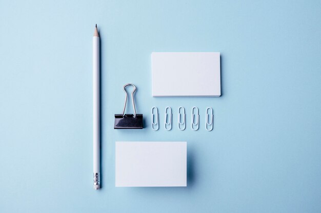 Top view white stationery items and business cards