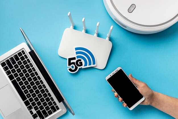top view of wi-fi router with laptop and vacuum cleaner