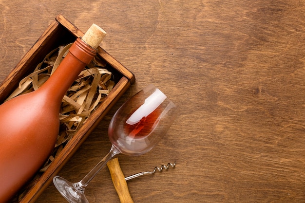 Top view wine bottle and glass with corkscrew and copy-space