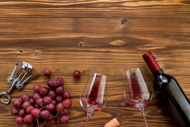 Top view wine bottle with glass on wooden background