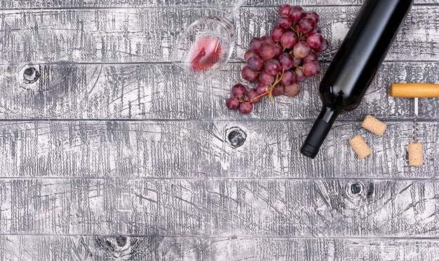 Top view wine bottle with grape and copy space on white wooden  horizontal