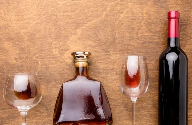 Top view wine and cognac bottles with glasses