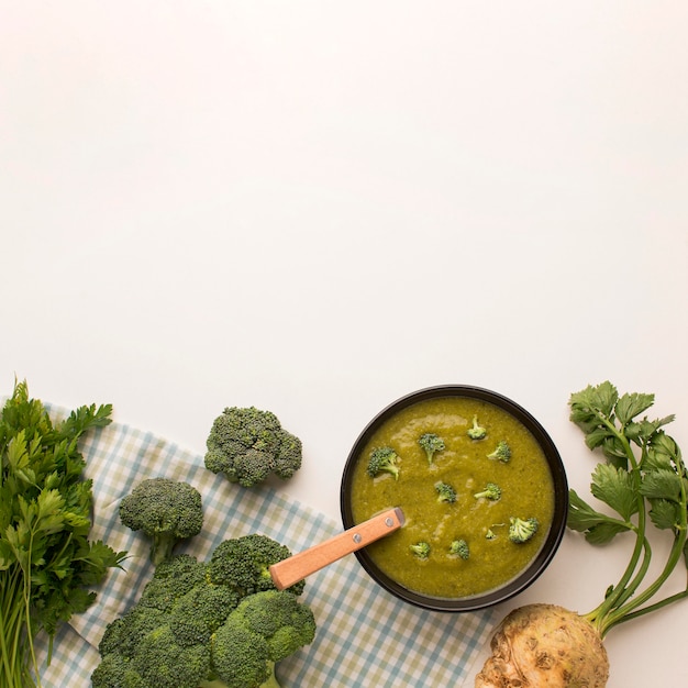 Top view of winter broccoli soup with celery and copy space