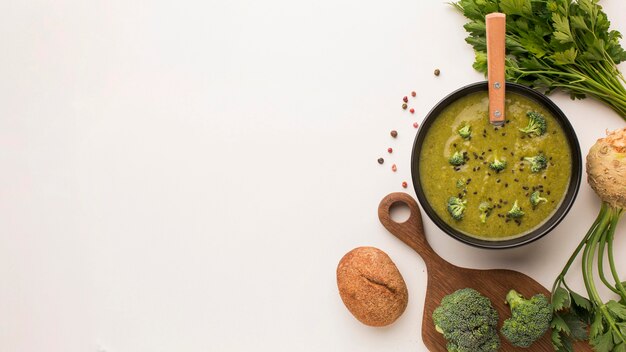 Top view of winter broccoli soup with copy space and celery