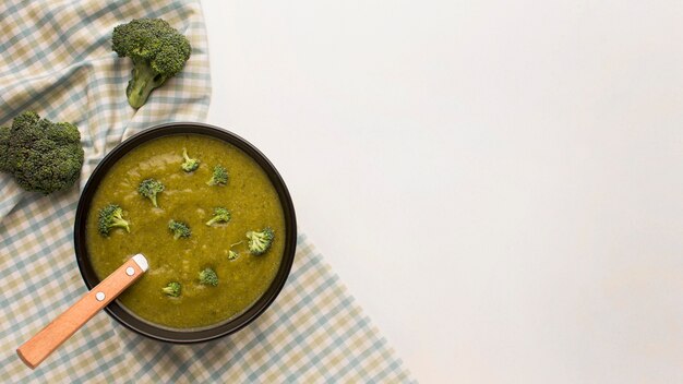 Top view of winter broccoli soup with copy space