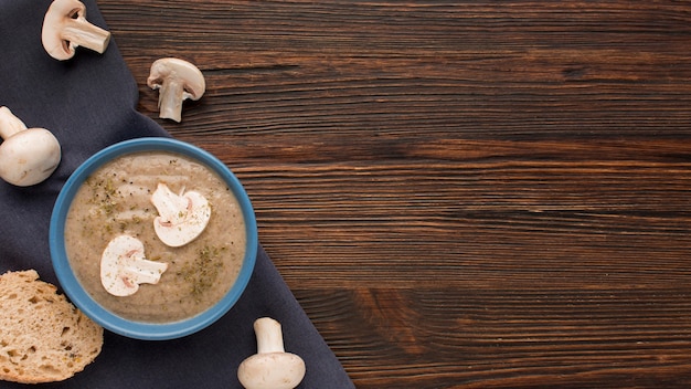 Top view of winter mushroom soup in bowl with copy space