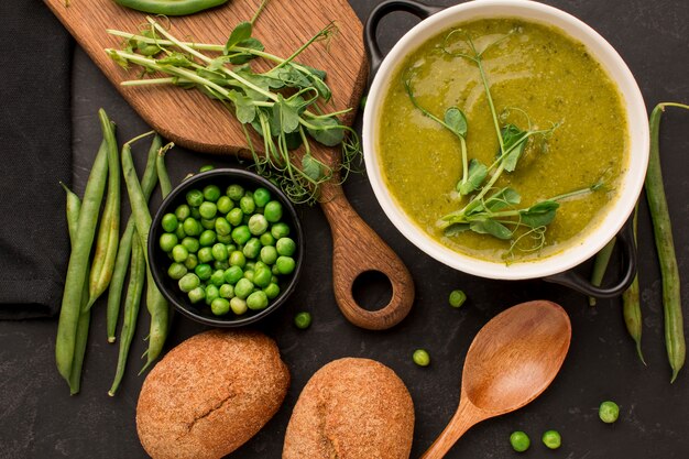 Top view of winter peas soup with bread and spoon