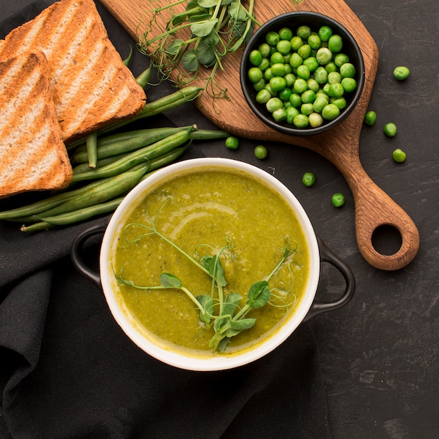 Top view of winter peas soup with toast