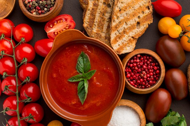 Top view of winter tomato soup in bowl with toast